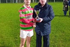 Tracton U21 C Hurling Captain Cian Quinn receiving the trophy from Vice-Chair Kevin O’Donovan