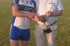 Belgooly Captain Rong Lomg receiving the JBFL trophy from Chairman Myles Barry
