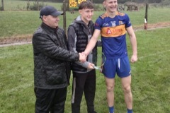 Mossy Vaughan receiving his Man of the Match award from Cormac & Killian Fitzgerald.