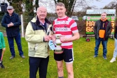 Ballygarvan-captain-Gary-White-receiving-the-SE-JAFC-trophy-from-Chairman-Myles-Barry